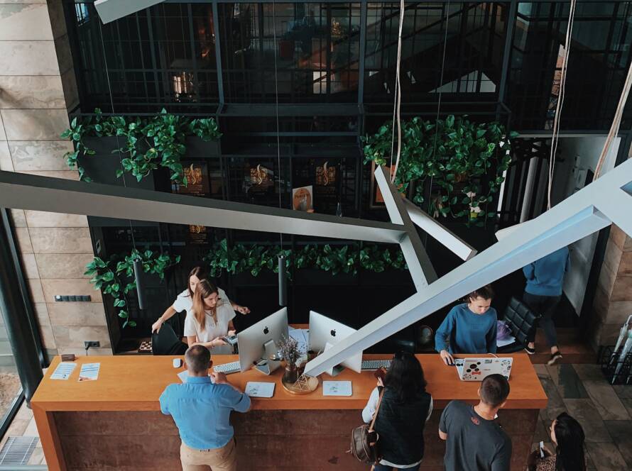 Guests at a hotel front desk seen from above