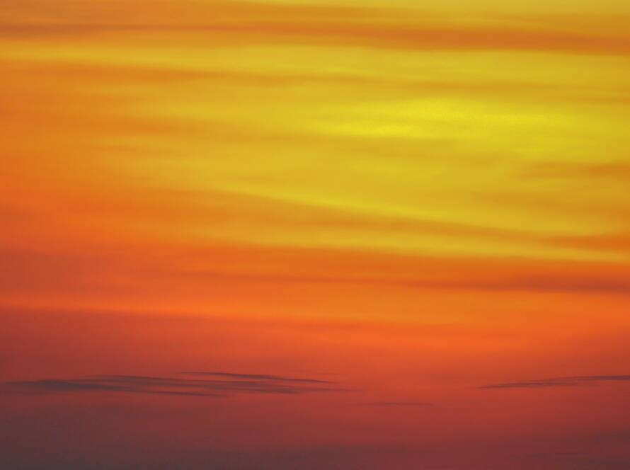 Orange sunset sky over a setting sun
