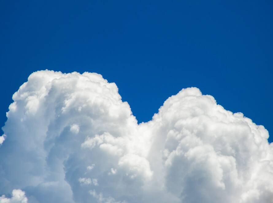 White cumulus clouds against a blue sky
