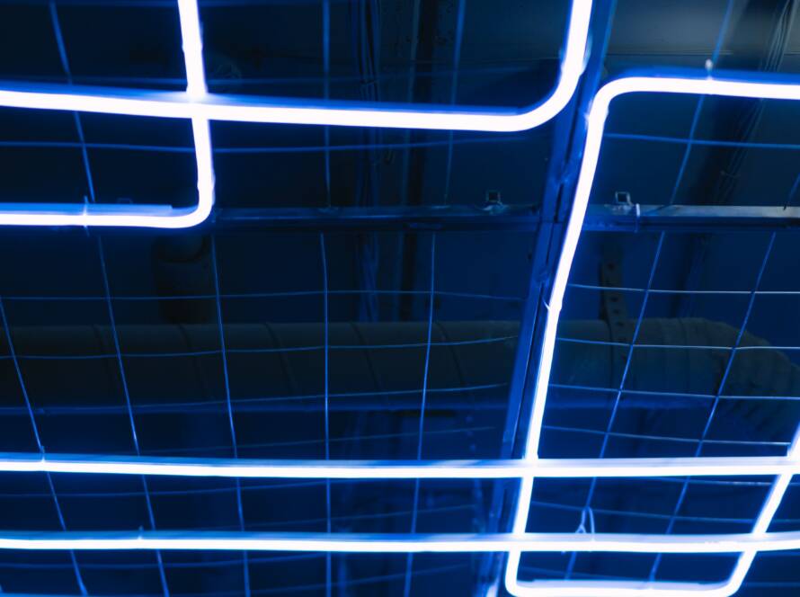 Blue neon light lines on a dark ceiling
