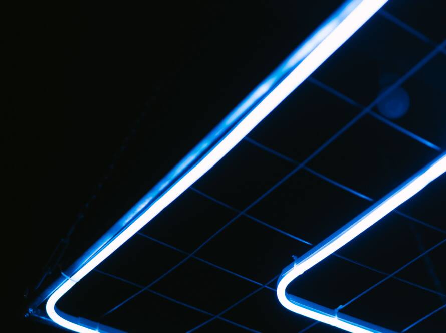Glowing blue neon light lines forming angled shapes against a dark background