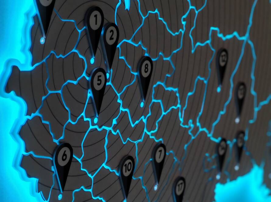 Illuminated map with numbered location pins and glowing blue borders, illustrating 5G network coverage