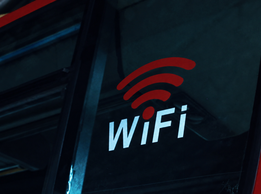 Red and white WiFi symbol and word "WiFi" on a dark sign
