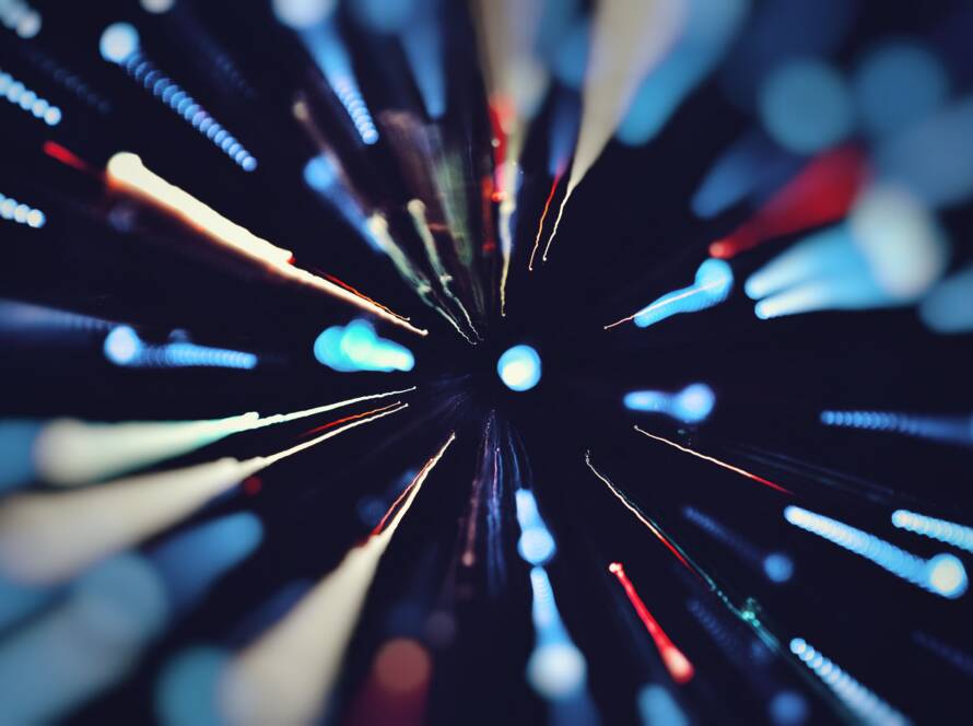 Abstract streaks of colored light radiating outward in a speed-of-light effect