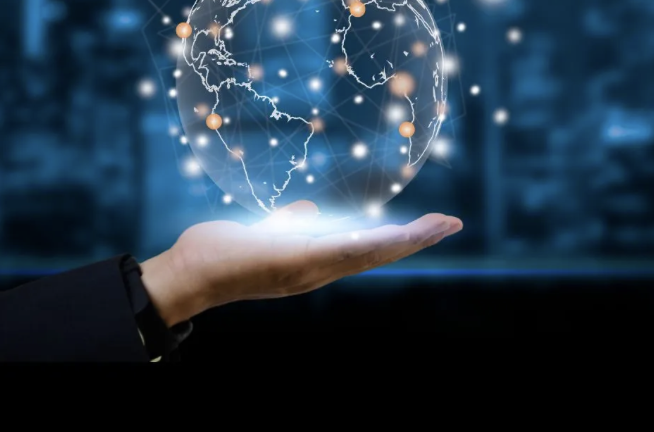 Hand holding a glowing digital globe with network points