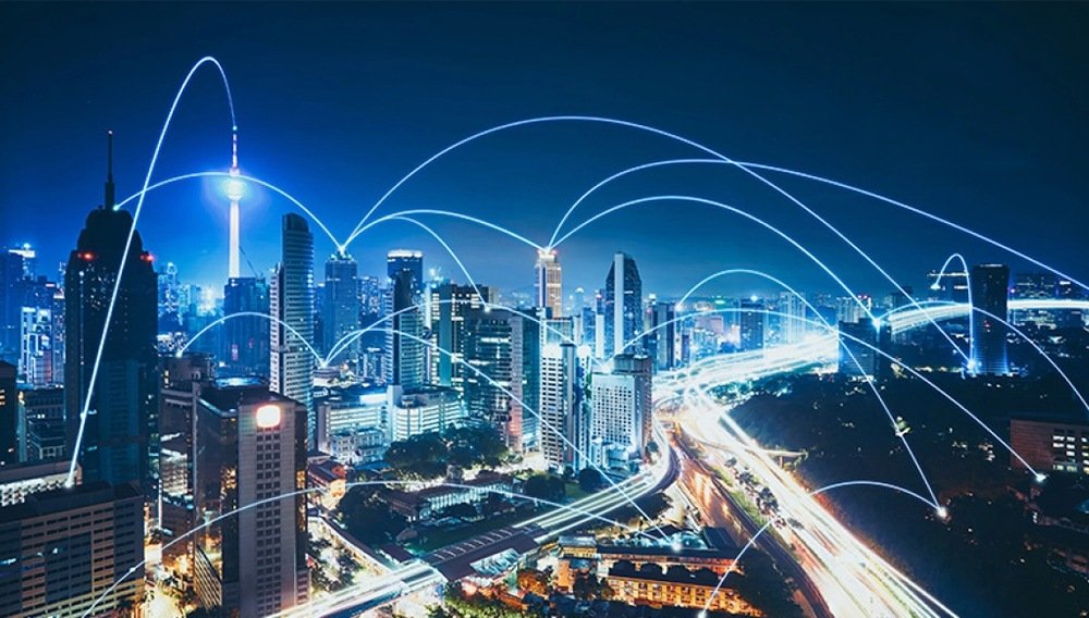 Night city skyline with glowing network connection lines representing 5G