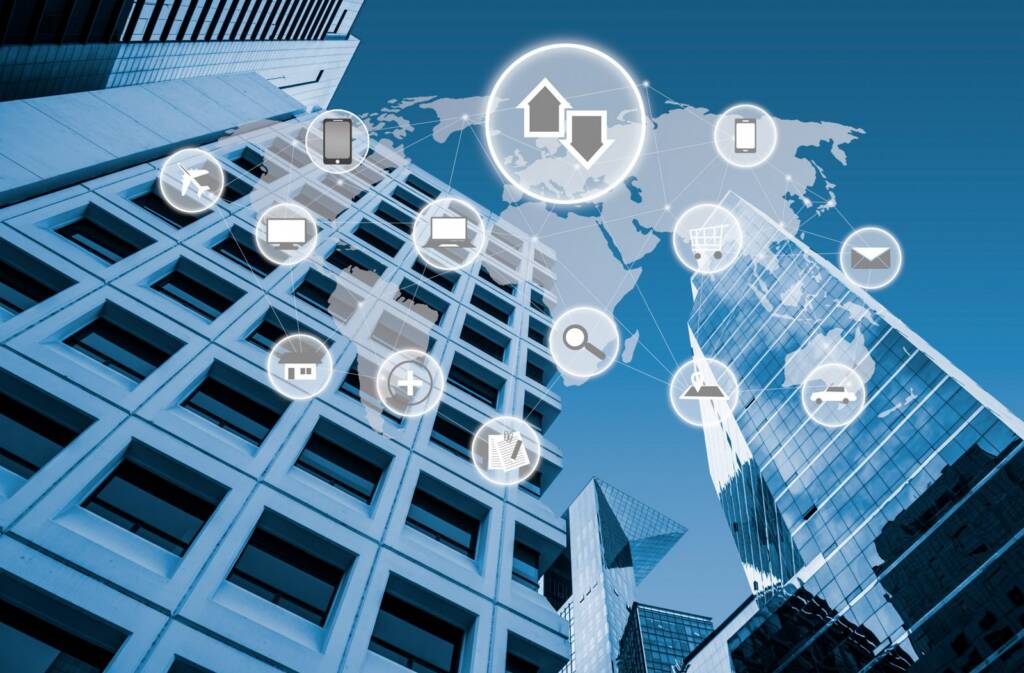 Office towers overlaid with a world map and connected device and network icons