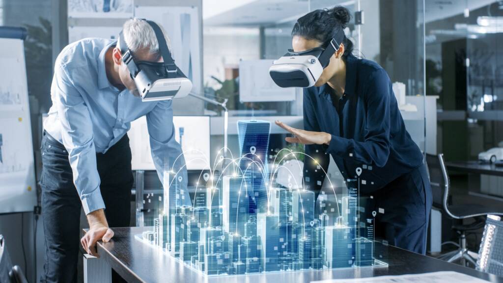 Two architects in VR headsets working with a holographic 3D city model