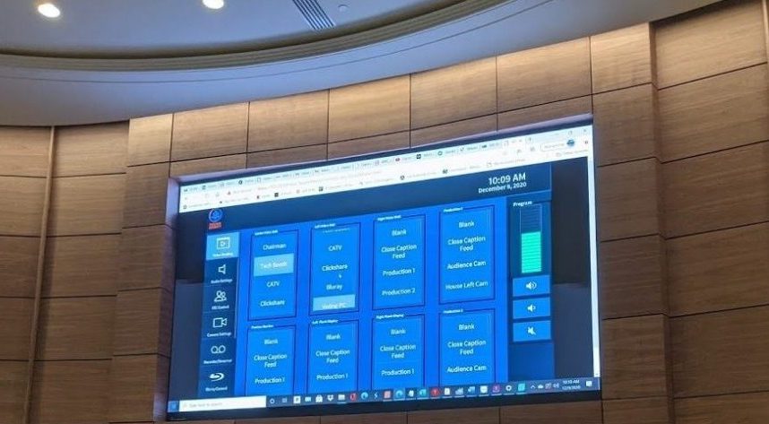 Large video wall in the Fulton County chambers showing an AV control interface