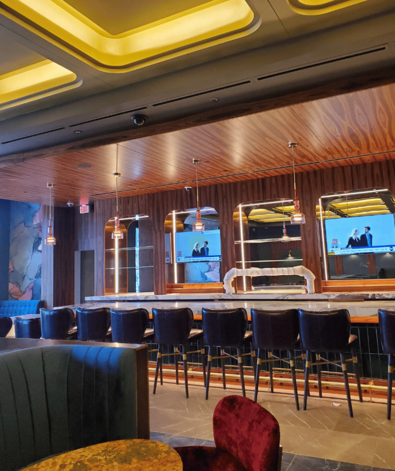 Wind Creek bar with blue stools, wood ceiling and TVs