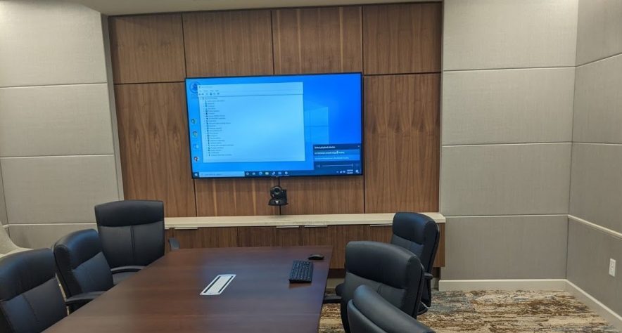 Fulton County conference room with wall-mounted display, table and leather chairs