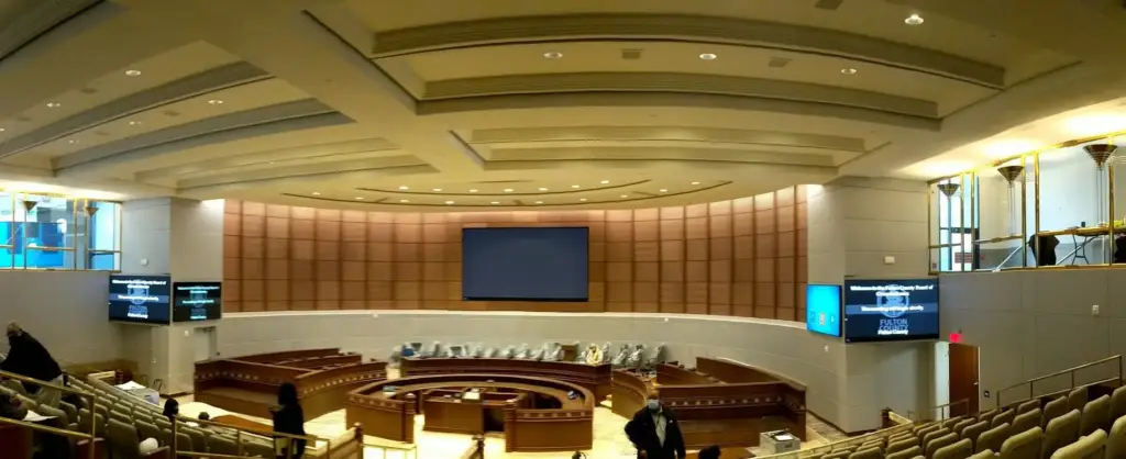Panoramic view of the renovated Fulton County Board of Commissioners chamber with dais and displays