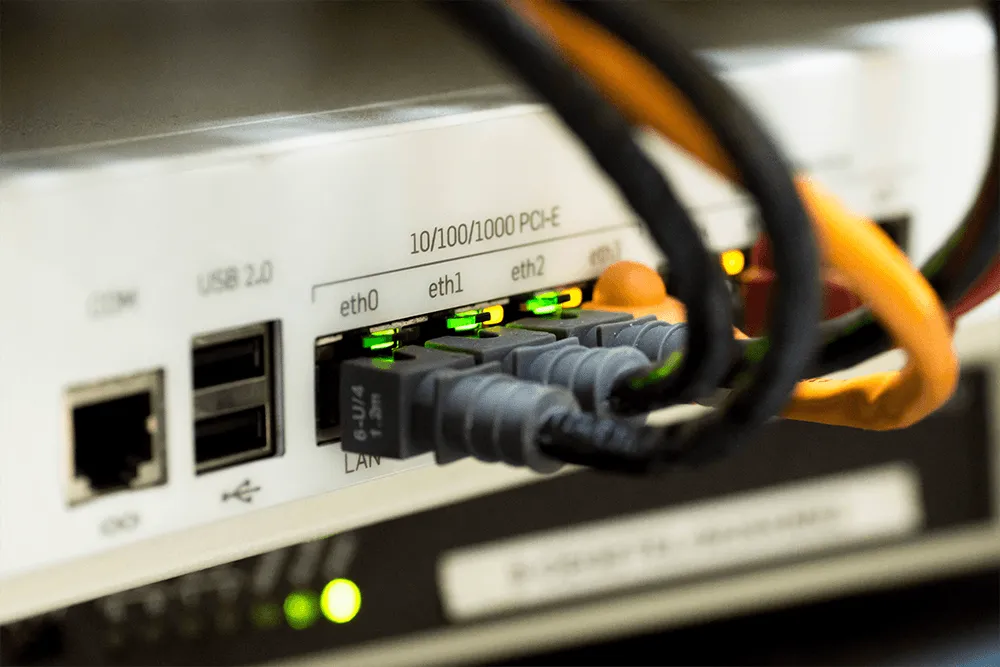 Network cables plugged into Ethernet ports on a device in an MDF