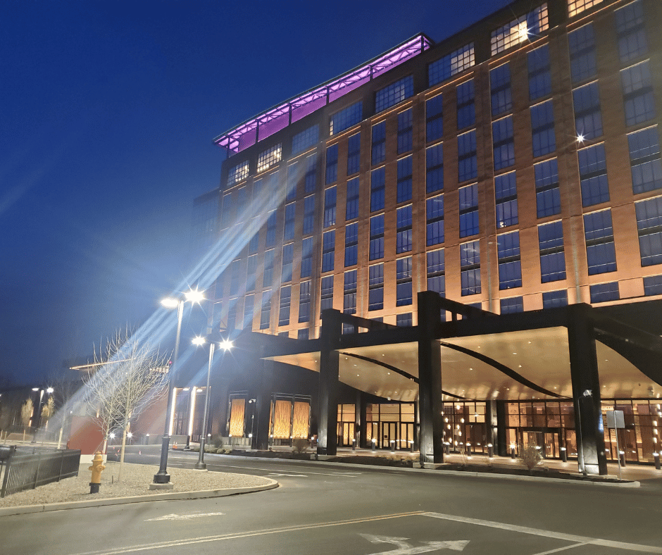 Exterior of the Wind Creek hotel at night with its lit entrance canopy