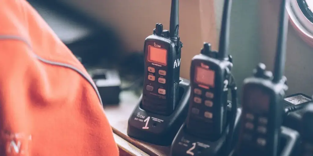 Row of handheld two-way radios in charging cradles