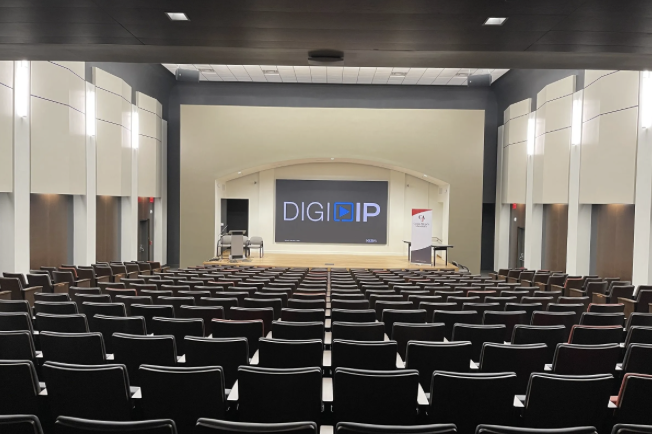 Aldridge Auditorium seating facing the stage with a DIGI IP display