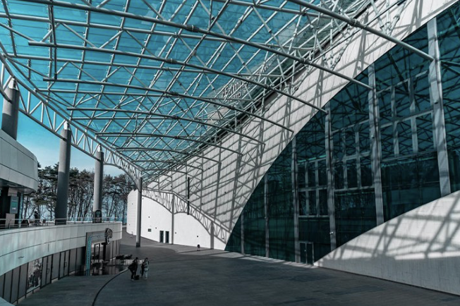 Curved glass and steel canopy over the plaza of a modern convention building