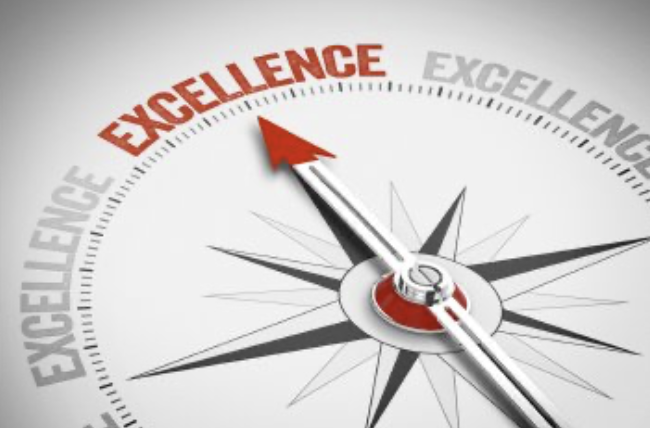 Compass needle pointing to the word "Excellence"