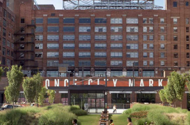Ponce City Market brick building exterior with sign and landscaped lawn in front