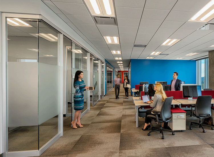 State Farm office with glass-walled offices, open workstations and a blue accent wall