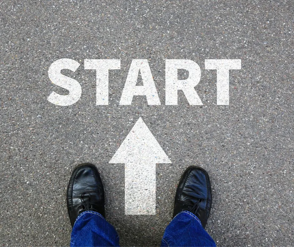 Feet standing on pavement at the word START with an arrow