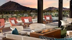 Rooftop terrace with fire pit and lounge seating facing mountains at Canopy by Hilton Scottsdale