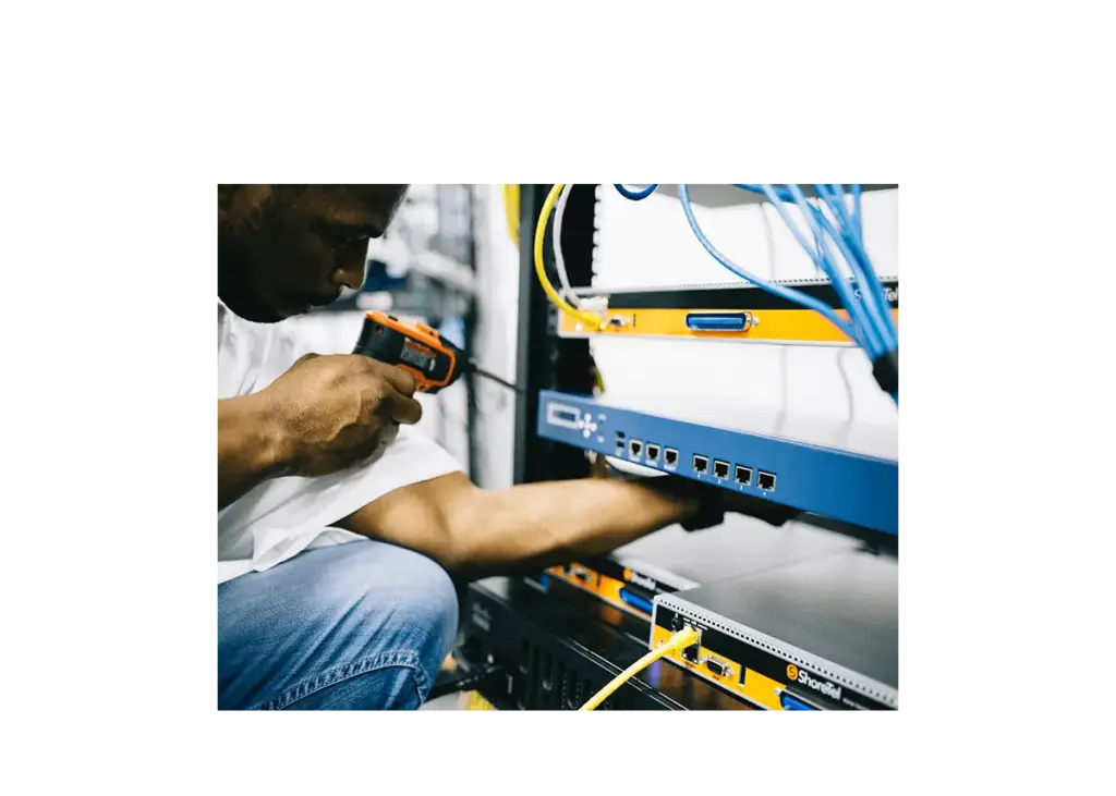 Engineer working on network cabling in an equipment rack
