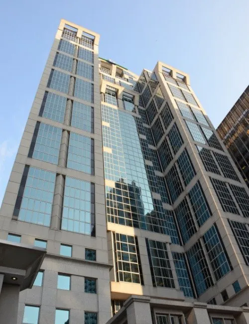 Upward view of a glass and stone Fifth Third office tower