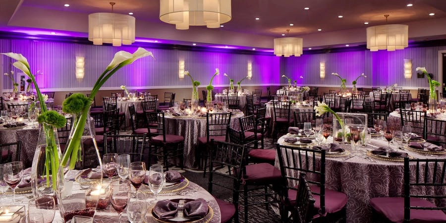 YOTEL Washington DC ballroom set for a banquet with purple uplighting and round tables