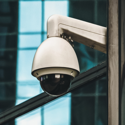 Dome security surveillance camera mounted on a building exterior