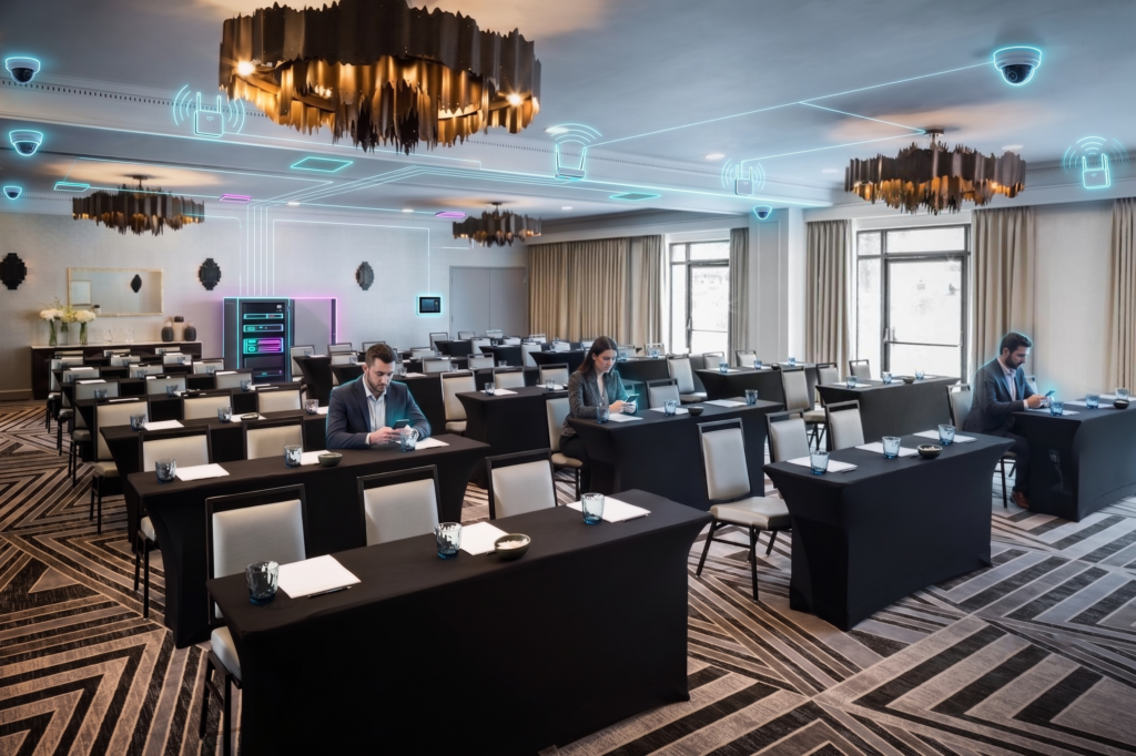 Meeting room at The Darcy Hotel set classroom style with overlaid network device icons