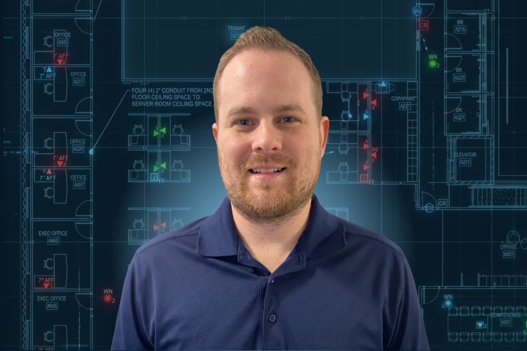 Matthew Winston in front of a glowing technology floor plan drawing
