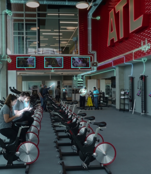 Rendering of a fitness studio with rows of spin bikes, a red ATL wall and glowing cabling overlays